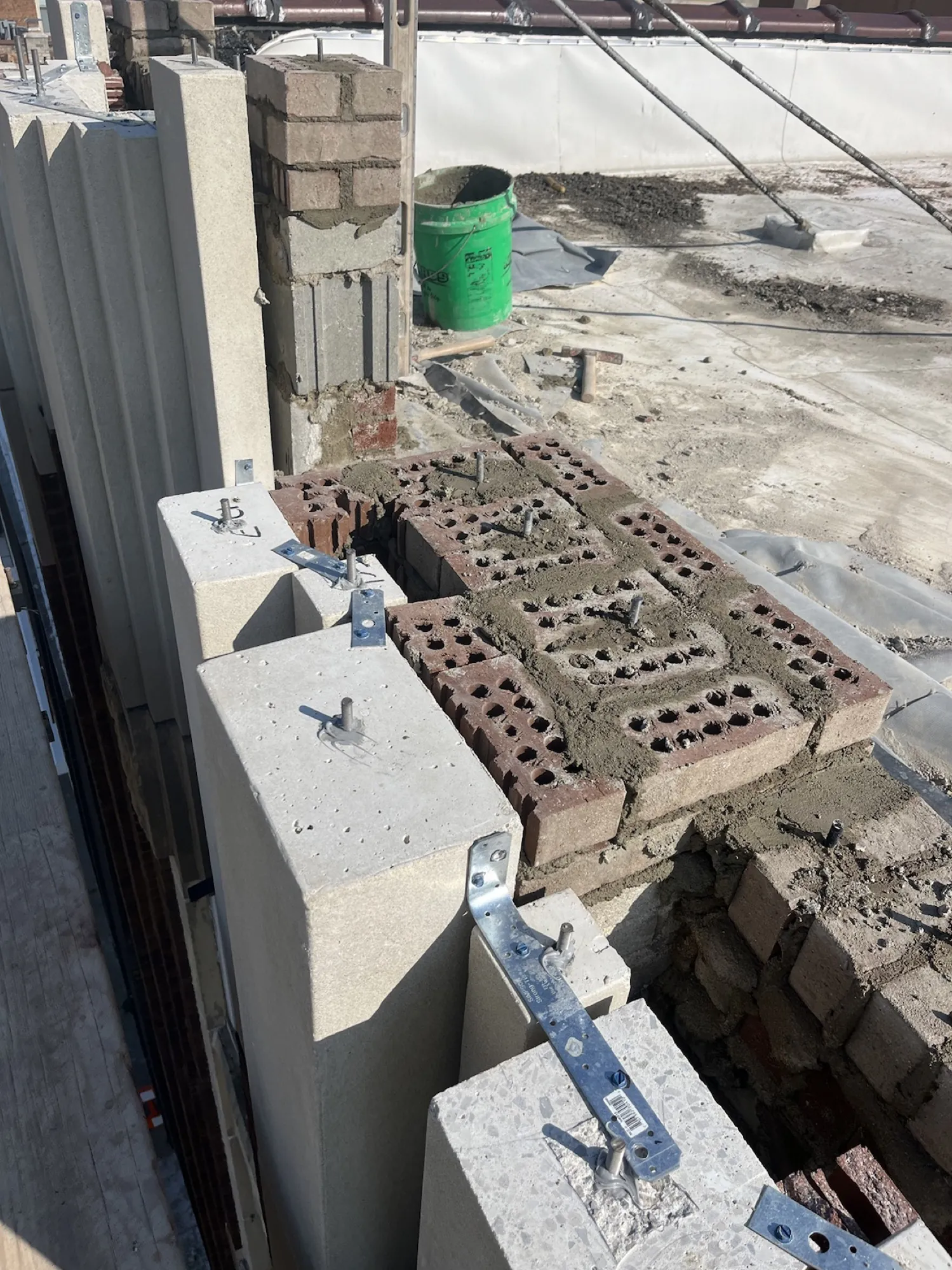 New cast stone with color-matched brick backup construction behind it.
