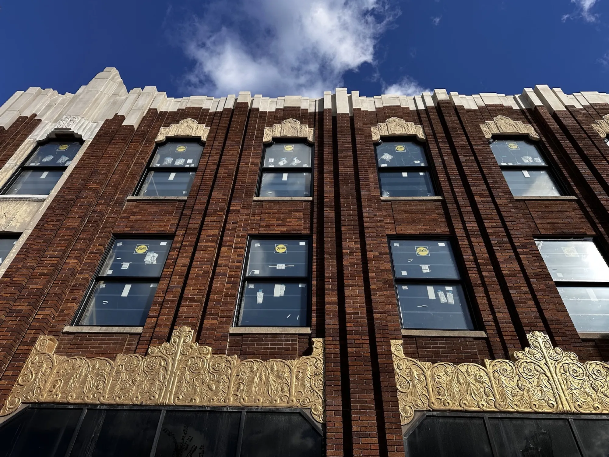 After — new cast stone above the surviving terra cotta frieze.